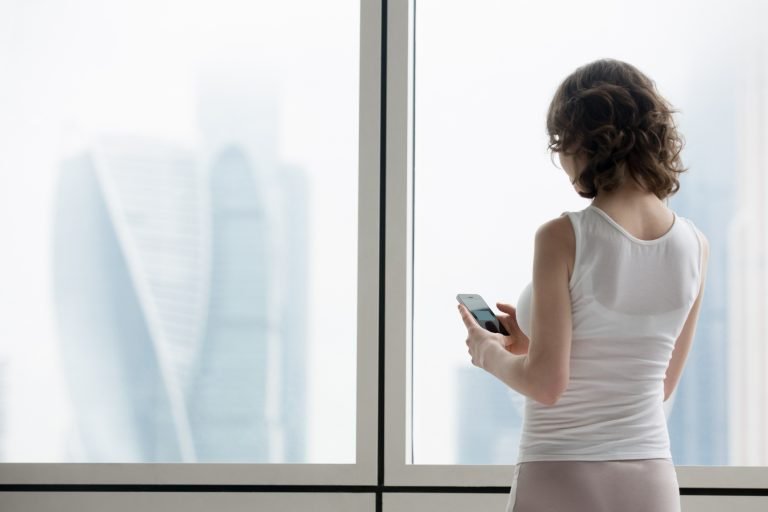 young woman using smartphone indoors